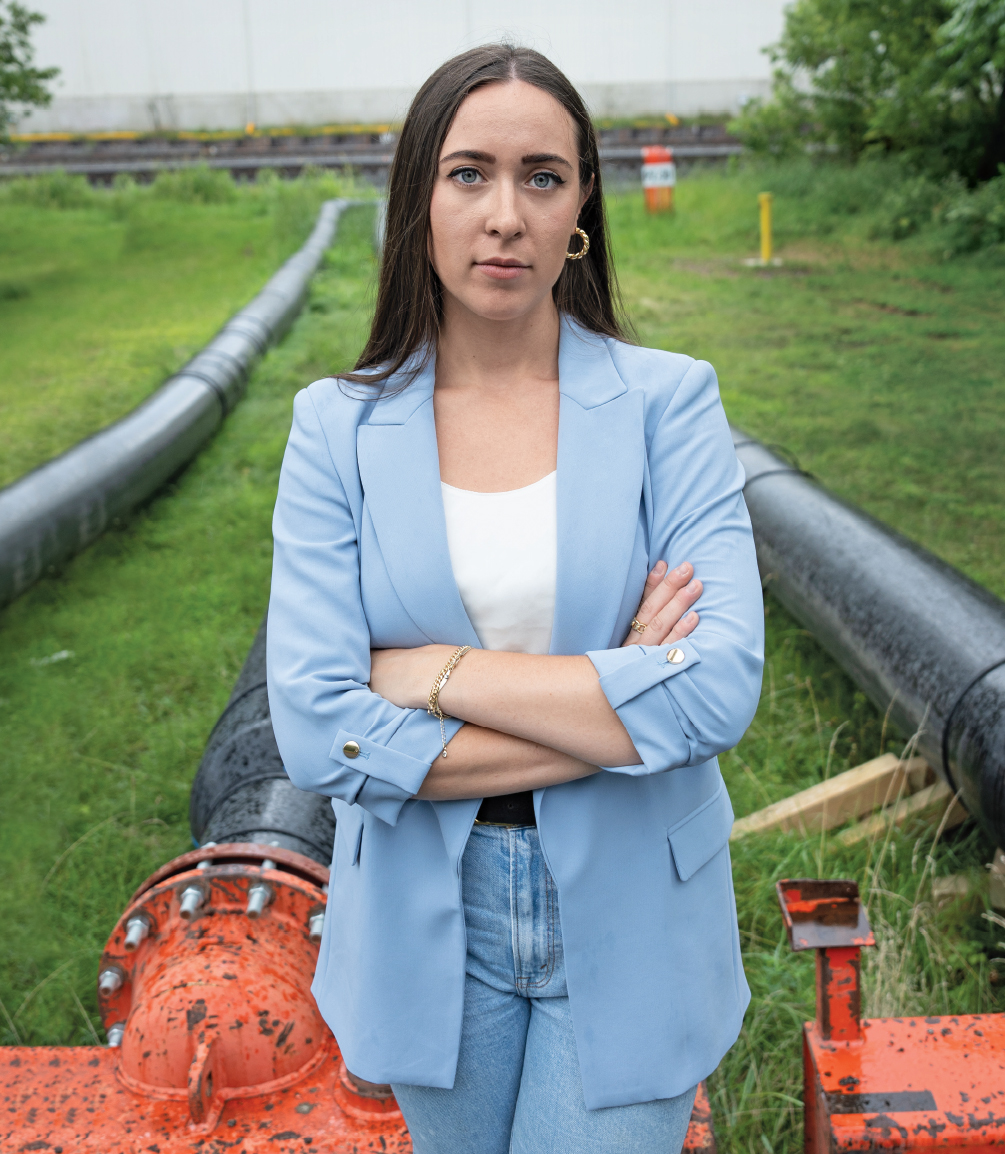 Jennifer Smith in East Palestine, Ohio, which is located about 30 minutes south of her hometown. Smith stands in front of pipes that were installed to divert clean water around the site where a freight train carrying hazardous materials derailed on February 3, 2023.