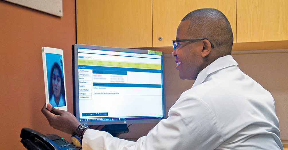 Stanley Gitau Mukundi, a physician assistant at Michigan Medicine, conducts a telehealth visit with a patient. Photo from Michigan Medicine, University of Michigan