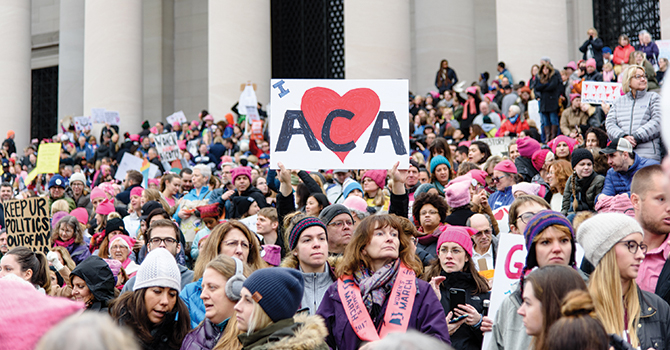 A crowd gathers on the steps of the Lincoln Memorial to support the Affordable Care Act