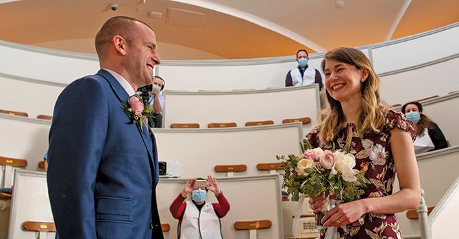 Jen Andonian, MPH ‘15 and Matt Shearer, MPH ‘14, pause on a busy work day in March, with a team of frontline-workers-turned-wedding-guests, to get married in the historic Ether Dome surgical theatre at Massachusetts General Hospital, just days after they had canceled their well-planned wedding.