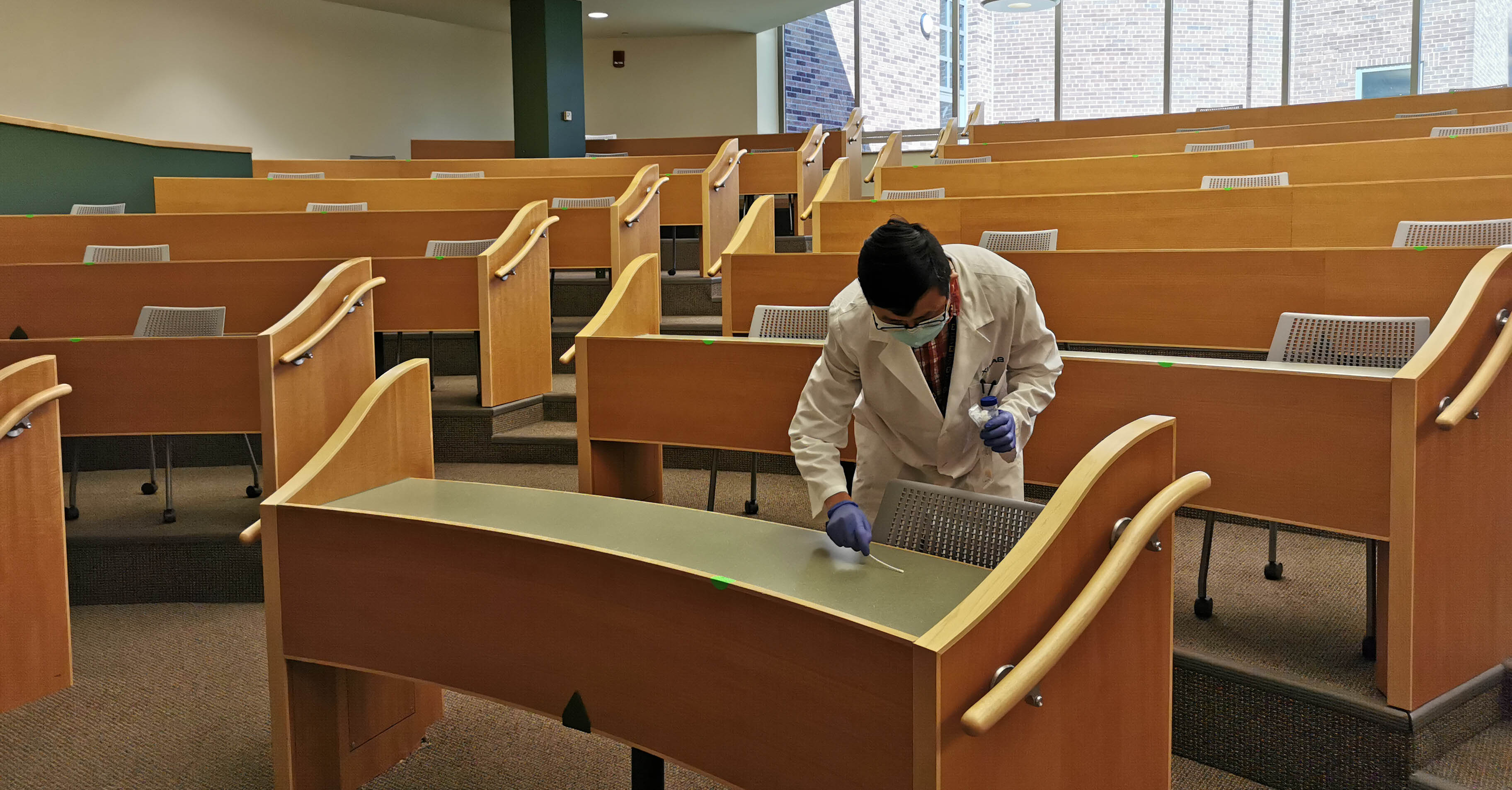 Jianfeng Wu, a research fellow at U-M's School of Public Health, collects samples of surfaces around U-M's Ann Arbor campus