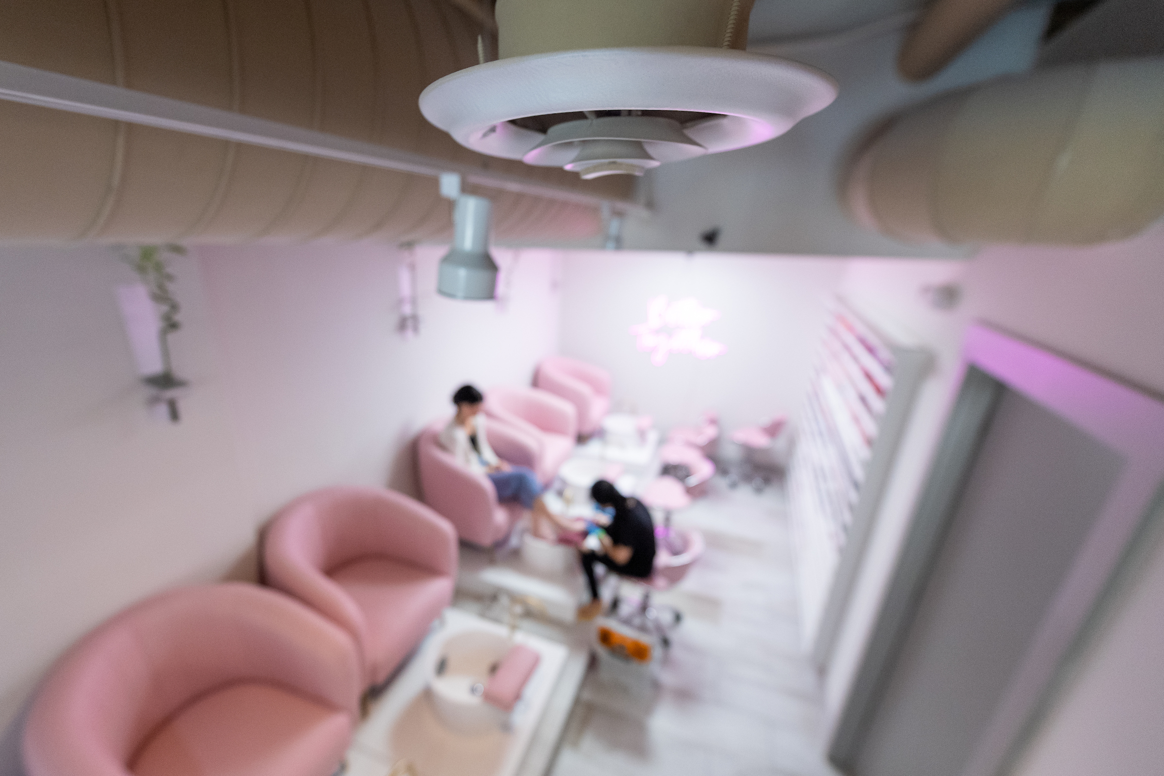 A ventilation system on the ceiling of a nail salon.