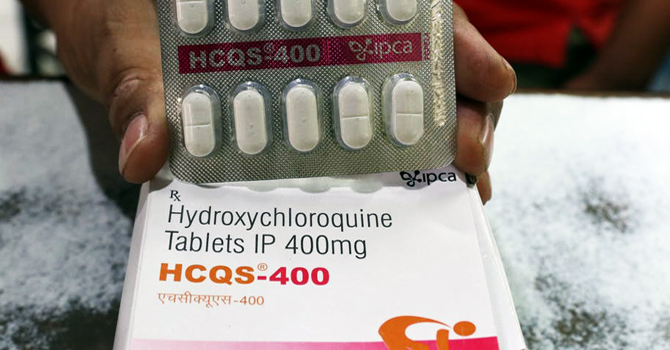 A pharmacist in India displays hydroxychloroquine tablets 